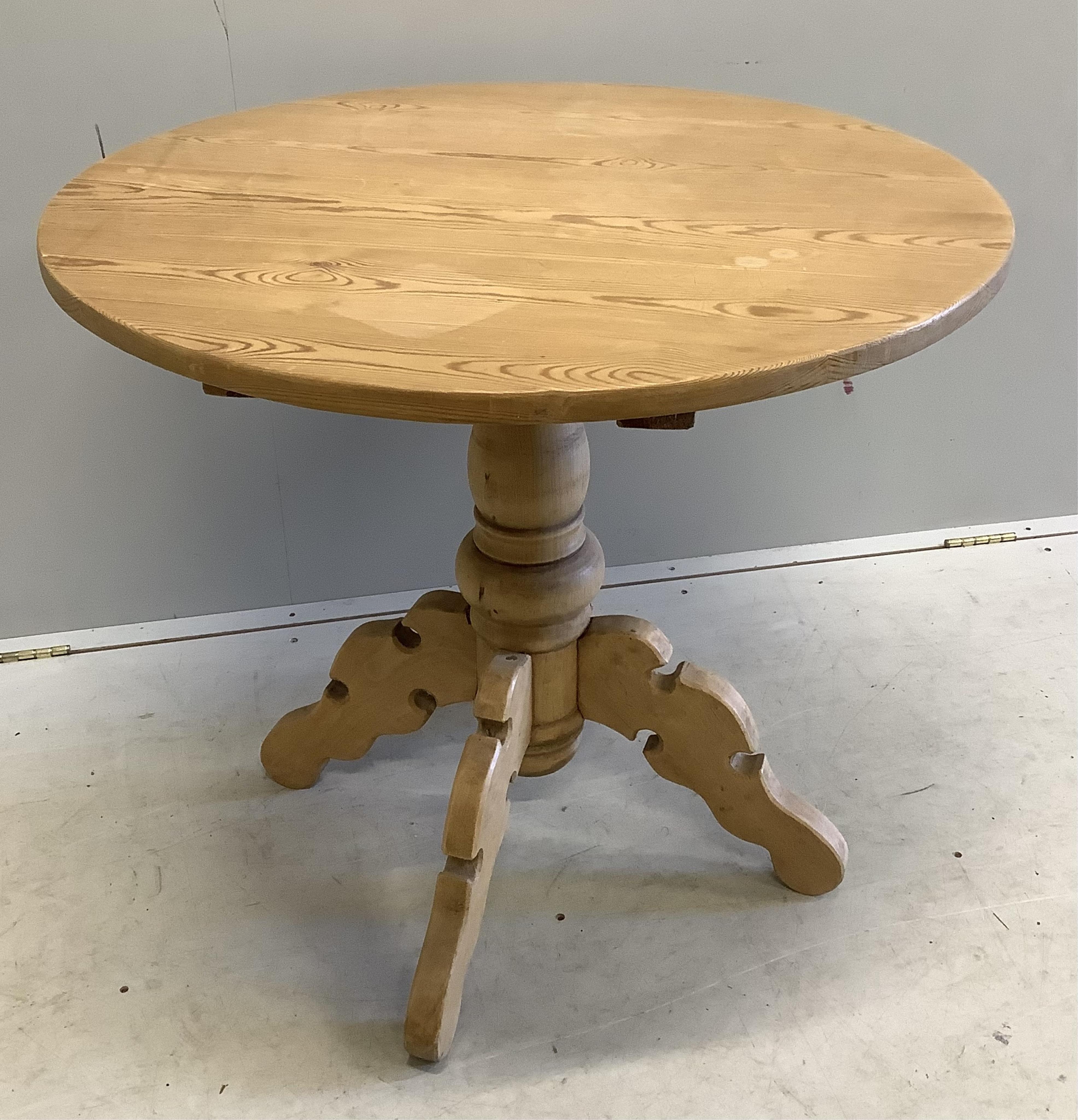 A Victorian style circular pine centre table, diameter 83cm, height 75cm. Condition - fair